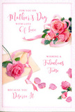 This Mother's Day card appears like a delicate floral still life, captured in soft focus and translated onto paper. Against a clean, light background, romantic clusters of blush and rose-pink flowers gather in one section of the card, with the largest roses placed centrally, their full, layered petals unfolding like tiny satin ruffles. The colour transitions from pale, almost-white pink at the edges to deeper, warmer tones in the heart of each bloom, creating a sense of fullness and life, as though they were just cut from a garden in Dollis Hill at first light. Around the main bouquet, individual petals have drifted and settled randomly, adding a sense of intimacy and movement, much like the gentle scattering that happens on a florist's workbench while arranging a Mother's Day gift. A soft, pastel ribbon winds gracefully through the flowers, its loops and tails echoing the curves of the petals and giving the impression of a lovingly tied gift. Elegant calligraphy, flowing and slightly whimsical, spells out a message of gratitude and celebration for Mum, the words positioned so they seem to float among the flowers rather than simply sit on top of them. The lighting is calm and flattering, without glare, giving the card a warm, inviting presence - the kind of design you imagine resting on a mantlepiece in a Dollis Hill home alongside a freshly delivered bouquet and maybe a tray of breakfast treats. The overall mood is one of gentle affection, quiet appreciation, and the simple joy of saying thank you in a beautifully floral way.
